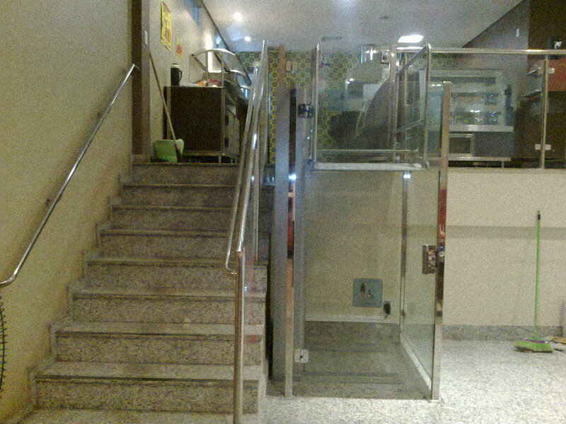 Plataforma elevatória cabinada instalada ao lado de escada